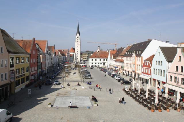 Der Hauptplatz vor und nach der Umgestaltung: wo zuvor Verkehr dominiert hat, spielen jetzt Kinder und laden Straßencafés zum Verweilen ein.
