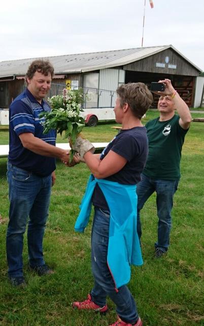 Fluglehrerin Barbara Kaiser überreicht Andreas den Brennnessel-Strauß