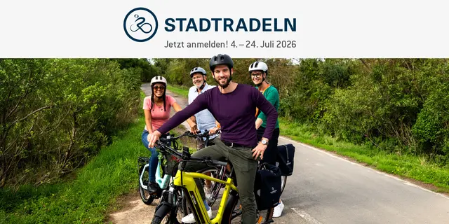 Vier Personen stehen an einem Radweg mit ihren Rädern und lächeln in die Kamera.